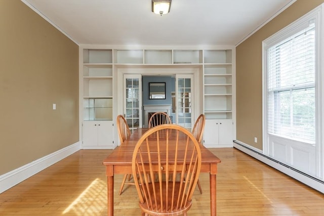 36 7th St, New Bedford, MA 02740 - dining room featuring baseboard heating, built in features, ornamental molding, light wood-style flooring, and plenty of natural light