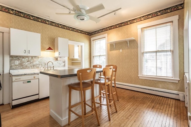 36 7th St, New Bedford, MA 02740 - kitchen featuring a baseboard heating unit, white dishwasher, light wood-style flooring, ceiling fan, and white cabinets