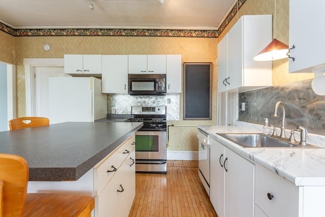 36 7th St, New Bedford, MA 02740 - kitchen featuring black microwave, stainless steel range oven, freestanding refrigerator, a sink, and dishwashing machine