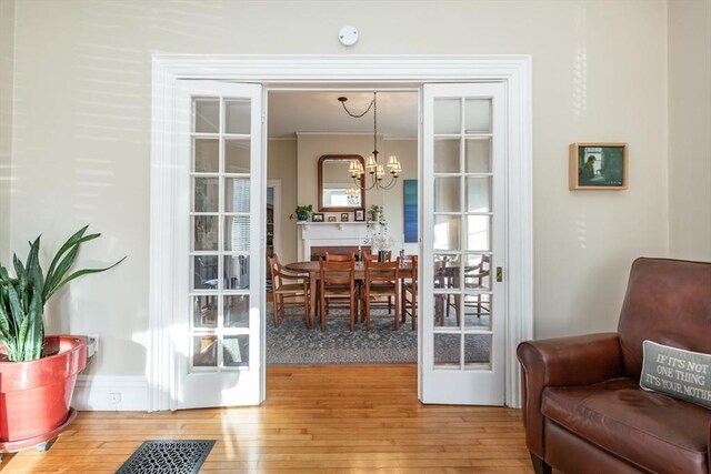 36 7th St, New Bedford, MA 02740 - entryway with wood-type flooring and a chandelier