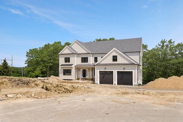 19 Couture Way, Middleton, MA 01949 - view of front of house with board and batten siding, a garage, and a shingled roof