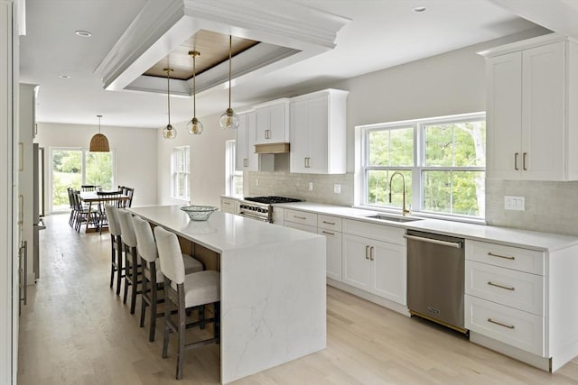 19 Couture Way, Middleton, MA 01949 - kitchen featuring stainless steel appliances, light wood-style flooring, a breakfast bar area, tasteful backsplash, and recessed lighting