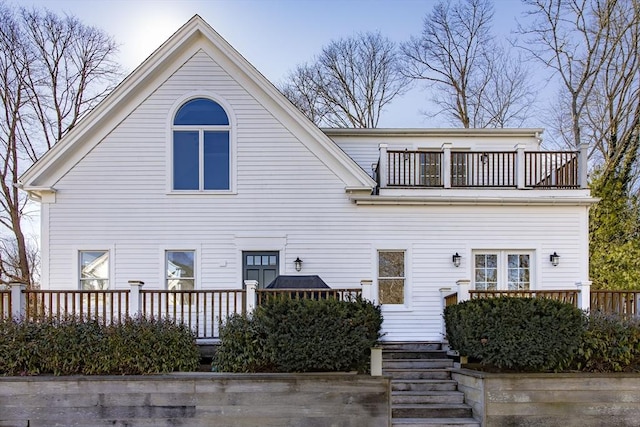 back of house featuring a balcony