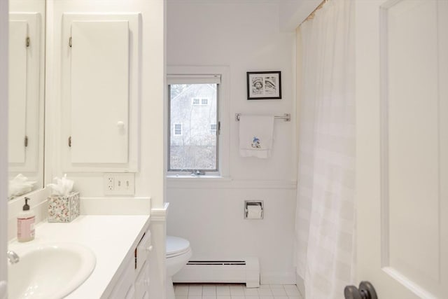 bathroom with baseboard heating, vanity, toilet, and tile patterned flooring