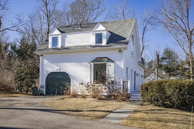 cape cod house with a garage