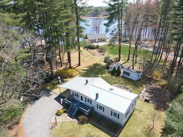 aerial view of property and surrounding area featuring a nearby body of water