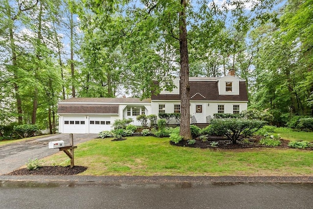 24 Squirrel Hill Rd, Acton, MA 01720 - dutch colonial featuring driveway, a garage, a front yard, a chimney, and roof with shingles