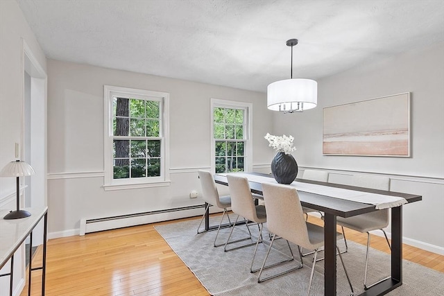 24 Squirrel Hill Rd, Acton, MA 01720 - dining room with a baseboard heating unit and wood-type flooring