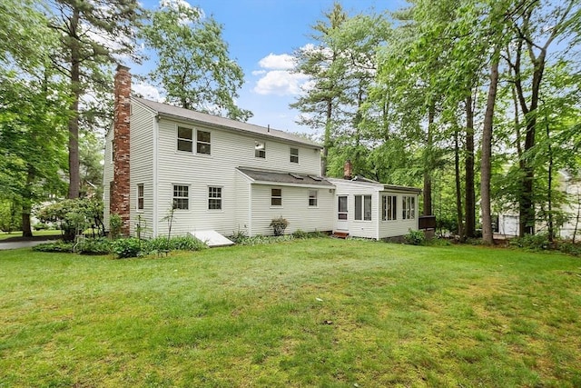 24 Squirrel Hill Rd, Acton, MA 01720 - back of property with a chimney, a sunroom, and a yard