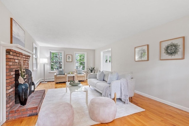 24 Squirrel Hill Rd, Acton, MA 01720 - living room with wood finished floors, a brick fireplace, and a baseboard heating unit