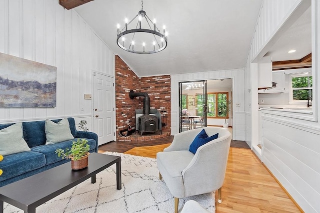 24 Squirrel Hill Rd, Acton, MA 01720 - living room featuring a wood stove, a chandelier, light wood finished floors, plenty of natural light, and lofted ceiling