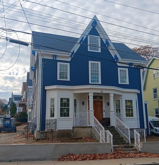 view of front of home featuring a porch and a shingled roof