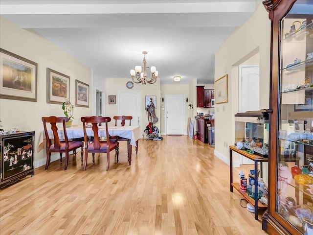 dining space with a chandelier and light wood-type flooring