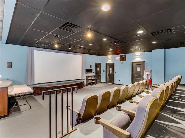 cinema room with a drop ceiling and rail lighting