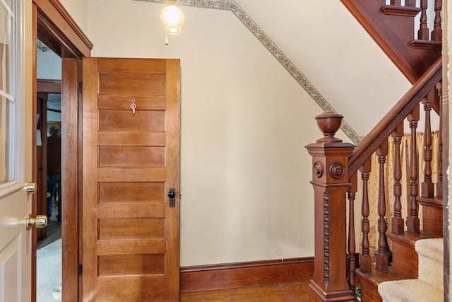 stairs featuring baseboards and wood finished floors