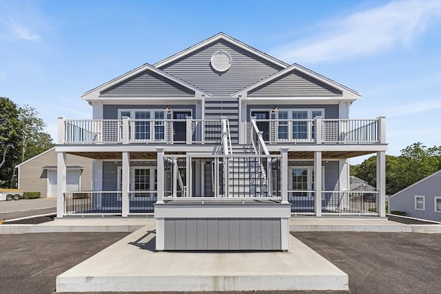 112 W Main Unit 5, Barnstable, MA 02601 - rear view of property with a balcony, a covered hot tub, a patio, and stairs