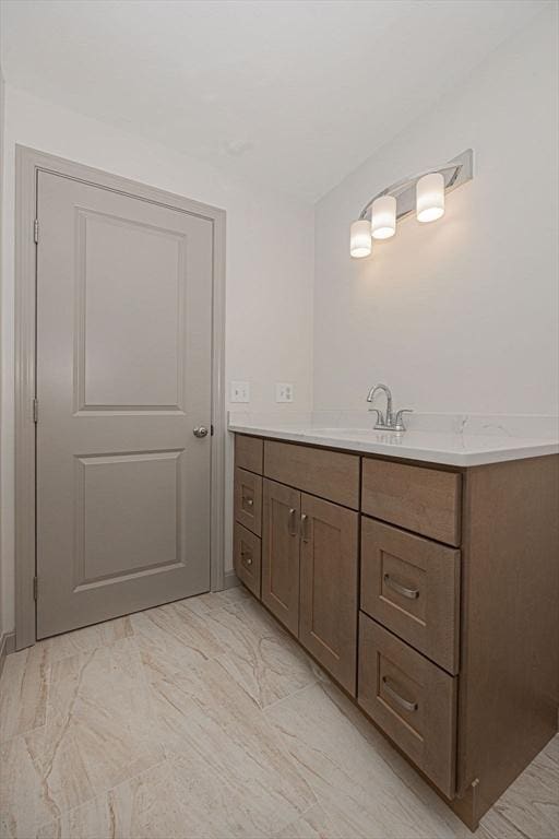 bathroom featuring marble look tiles and vanity