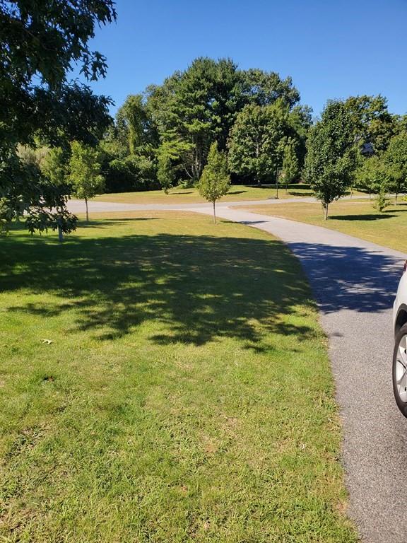 view of property's community with a lawn