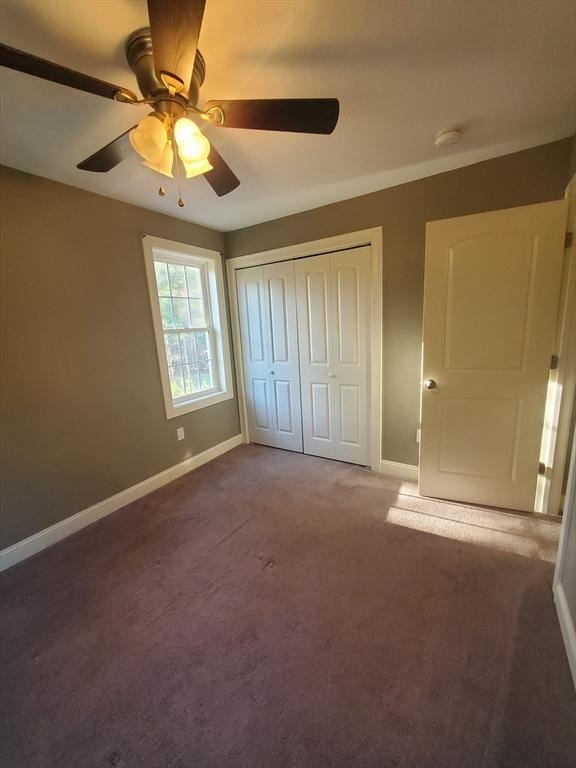 unfurnished bedroom with ceiling fan, a closet, and carpet floors