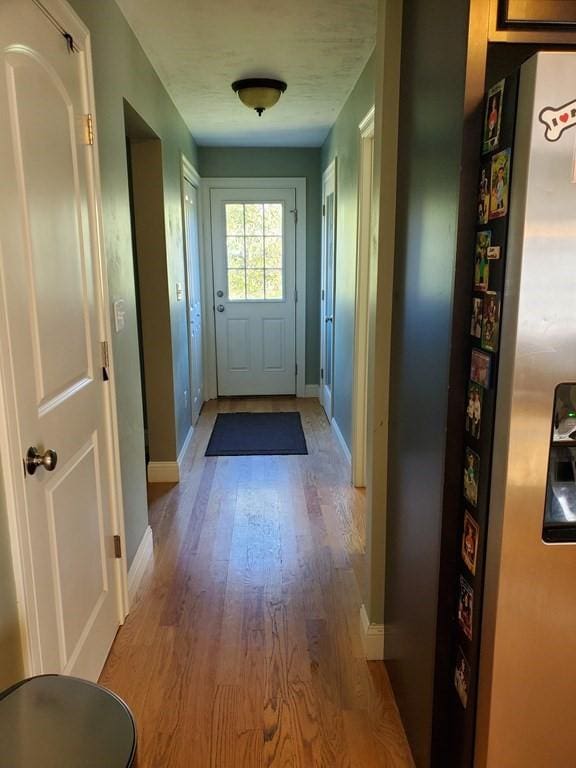 doorway to outside with light wood-type flooring