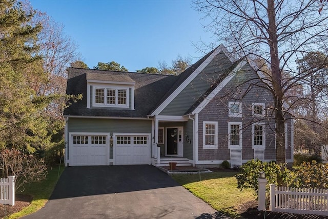 view of front of house featuring a garage and a front lawn