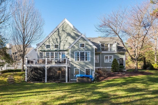 back of house with a deck and a yard