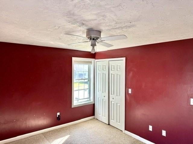 62 Moreland Green Dr, Worcester, MA 01609 - unfurnished bedroom with baseboards, light colored carpet, a closet, ceiling fan, and a textured ceiling