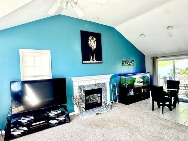 62 Moreland Green Dr, Worcester, MA 01609 - living room with vaulted ceiling, ceiling fan, and a high end fireplace