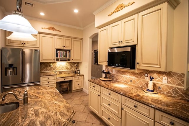 kitchen with high end fridge, hanging light fixtures, sink, and dark stone counters