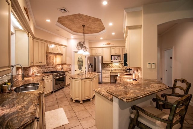 kitchen with sink, appliances with stainless steel finishes, hanging light fixtures, custom exhaust hood, and kitchen peninsula