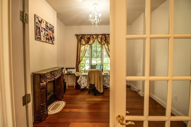 interior space with a notable chandelier and dark hardwood / wood-style flooring