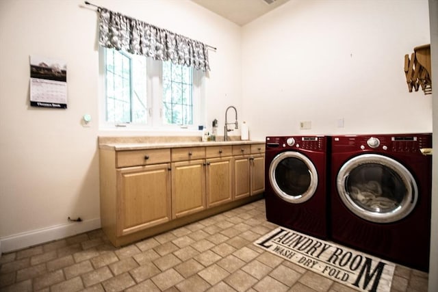 laundry room with cabinets, sink, and washer and dryer