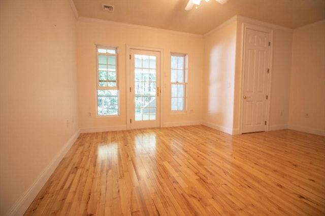 unfurnished room featuring ornamental molding, ceiling fan, and light wood-type flooring