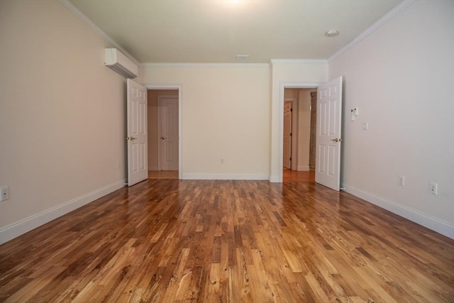 interior space featuring hardwood / wood-style flooring, ornamental molding, and an AC wall unit