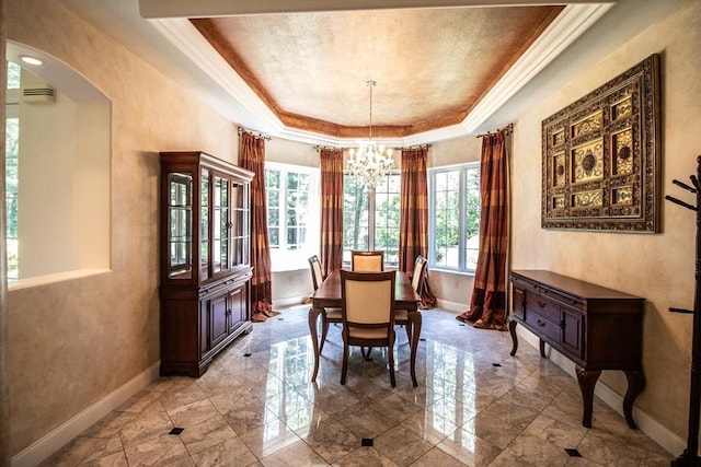 dining space featuring a raised ceiling, crown molding, and a notable chandelier