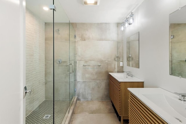 77 N End Blvd Unit 2, Salisbury, MA 01952 - bathroom with a stall shower, two vanities, and tile patterned flooring
