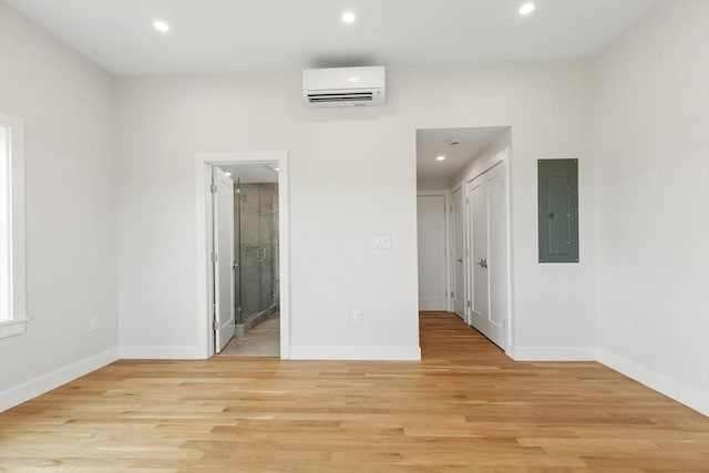 77 N End Blvd Unit 2, Salisbury, MA 01952 - empty room featuring a wall mounted AC, electric panel, recessed lighting, light wood-type flooring, and baseboards