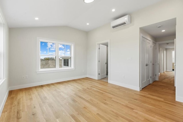 77 N End Blvd Unit 2, Salisbury, MA 01952 - spare room featuring a wall mounted AC, light wood-style floors, baseboards, vaulted ceiling, and recessed lighting