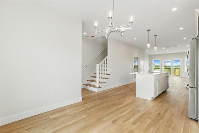 77 N End Blvd Unit 2, Salisbury, MA 01952 - kitchen featuring freestanding refrigerator, a sink, recessed lighting, light wood-type flooring, and light countertops