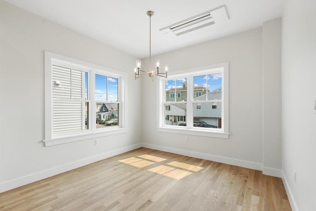 77 N End Blvd Unit 2, Salisbury, MA 01952 - spare room featuring a chandelier, light wood-style flooring, and baseboards