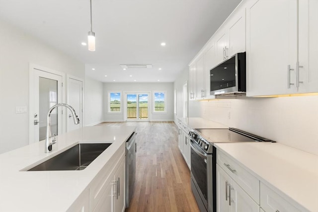 77 N End Blvd Unit 2, Salisbury, MA 01952 - kitchen featuring appliances with stainless steel finishes, a sink, light wood-type flooring, white cabinets, and recessed lighting