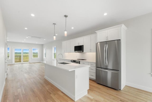 77 N End Blvd Unit 2, Salisbury, MA 01952 - kitchen featuring appliances with stainless steel finishes, white cabinetry, a sink, baseboards, and light countertops