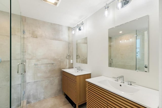 77 N End Blvd Unit 2, Salisbury, MA 01952 - bathroom featuring two vanities, a shower stall, and tile patterned floors
