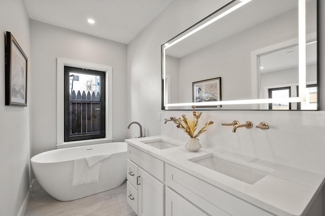 832 E 3rd Unit A, Boston, MA 02127 - full bathroom featuring double vanity, a freestanding tub, and recessed lighting