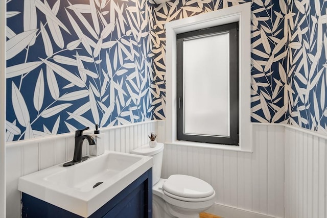 832 E 3rd Unit A, Boston, MA 02127 - half bathroom featuring wallpapered walls, wainscoting, vanity, and a decorative wall