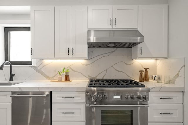 832 E 3rd Unit A, Boston, MA 02127 - kitchen featuring exhaust hood, stainless steel appliances, white cabinets, and light stone countertops
