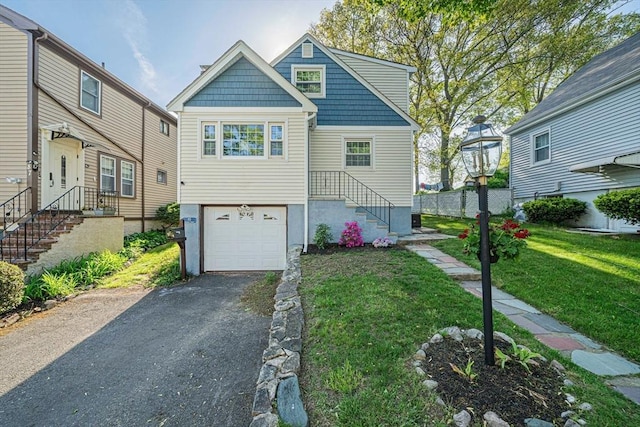 85 Salman St, Boston, MA 02132 - view of front of house with a garage, asphalt driveway, and a front yard