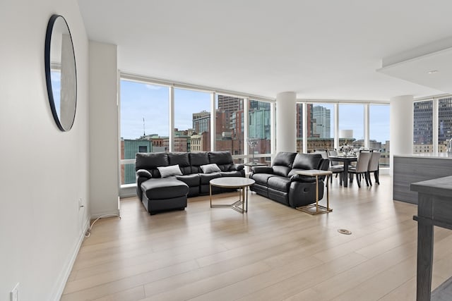 1 Franklin St Unit 1504, Boston, MA 02110 - living room with a view of city, a wall of windows, light wood finished floors, and baseboards