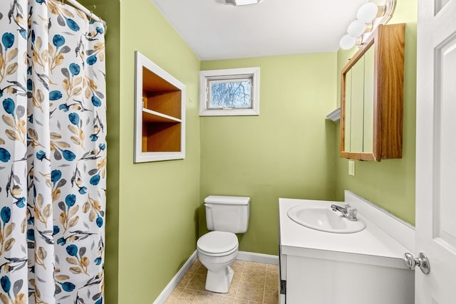 bathroom featuring toilet, vanity, tile patterned flooring, and walk in shower