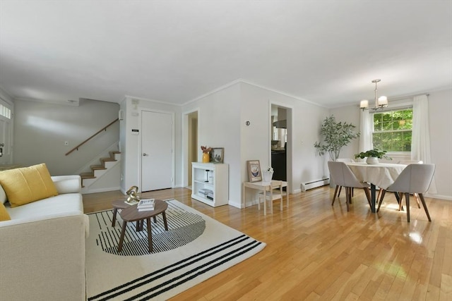 8 Edwards Rd Unit 8A, Woburn, MA 01801 - living room with a baseboard radiator, light wood finished floors, stairs, a chandelier, and baseboards